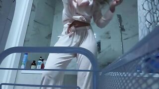 A petite girl caresses her sweet pussy in the bathroom, no one sees her