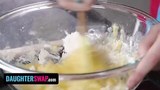 Two stepdaughters are baking a pie for their dads