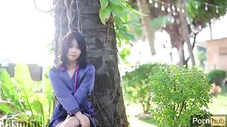 A cute Asian girl masturbates with a vibrator in the sunny garden