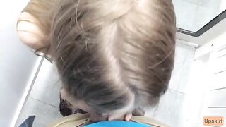 A petite girl was nearly caught while giving a blowjob in a shop changing room