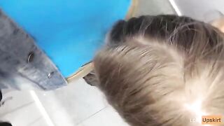 A petite girl was nearly caught while giving a blowjob in a shop changing room