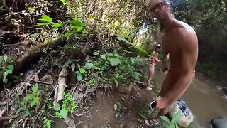 A couple are having fun in the river, deep in the jungle