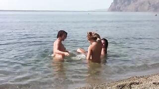 Three hot girls got naked on the crest of a public beach