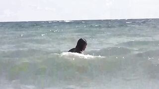 Two girls are having fun while sunbathing naked on the beach