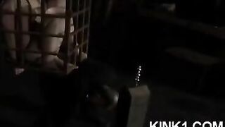 A slave is locked in a cage and forced to obey all the orders of the mistress