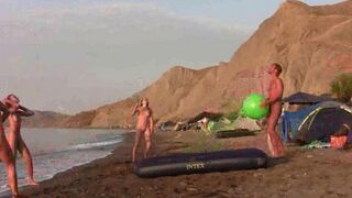 A badminton game with a sexy naked girl on the beach