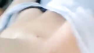 A half-naked girl is lying and caressing her body