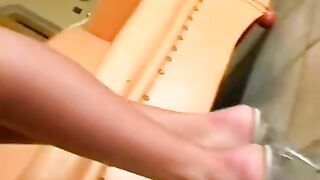 Nude beauty masturbates on a leather chair