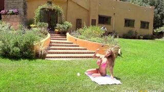 A blonde in a short summer dress has sex on the lawn
