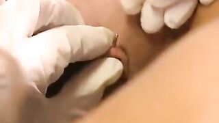 A girl with a large clitoris plays with her new piercing