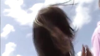 A young girl practices her skills with a guy with a shaggy haircut