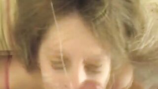 A cum shot on the face of a blonde after blowjob