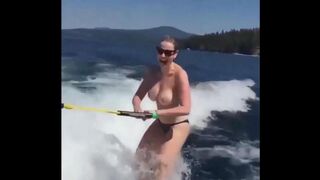 Topless girl skiing on water, her skills are impressive