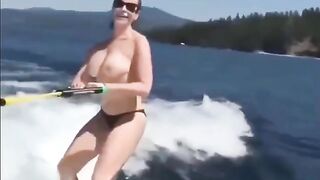 Topless girl skiing on water, her skills are impressive