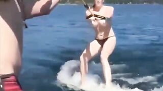 Topless girl skiing on water, her skills are impressive