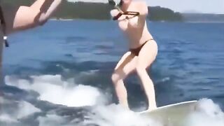 Topless girl skiing on water, her skills are impressive