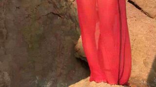 A sexy girl is walking on the naked beach and playing with her boobs