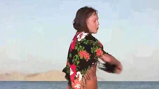 A member shows a naked girl on the beach some attention