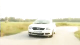A cute girl shows her shaved pussy on the bonnet and spreads it