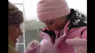 Two lesbians are having fun on a cold and snowy day in 2021