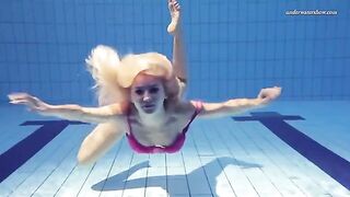 Nude beauty has fun in the pool, showcasing her carefree moment