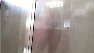 A guy washes himself in the shower, but there’s a camera watching