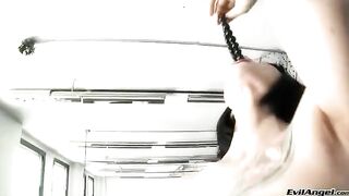 A sexy brunette in high heels masturbates with a dildo, screaming