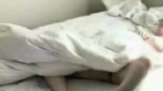 Someone masturbates in the bedroom, unaware of the hidden camera capturing the scene