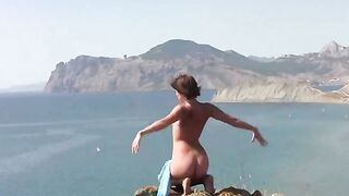 A girl is showing her body on the beach without clothes