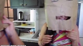 The little girls are wearing shopping bags on their heads and playing
