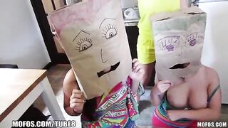 The little girls are wearing shopping bags on their heads and playing