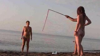 A cute girl is playing naked on the beautiful beach