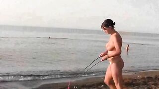 A cute girl is playing naked on the beautiful beach