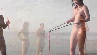 A cute girl is playing naked on the beautiful beach