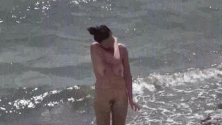A couple of free-spirited lovers enjoying each other on the nude beach