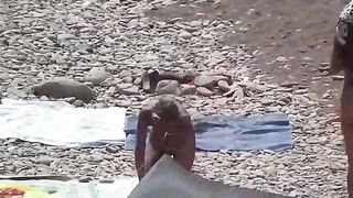 A couple of free-spirited lovers enjoying each other on the nude beach