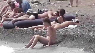 A couple of free-spirited lovers enjoying each other on the nude beach