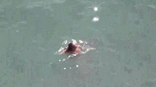 A pair of naked people are sailing on the sea