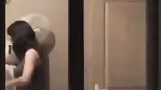 The guy admires himself in the mirror, standing completely naked in front of it