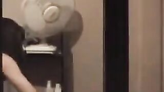 The guy admires himself in the mirror, standing completely naked in front of it