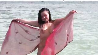 A young girl takes a sea bath naked