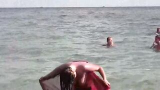 A young girl takes a sea bath naked