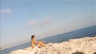 The girl has no shame and sunbathes completely naked on the beach