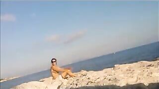 The girl has no shame and sunbathes completely naked on the beach