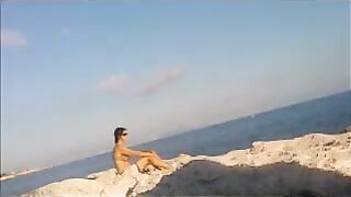 The girl has no shame and sunbathes completely naked on the beach
