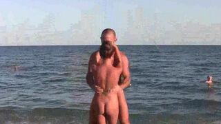 Nude beauties do acrobatic poses on the sandy beach