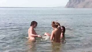 Nudist beauties have a great time on the beach without any clothes