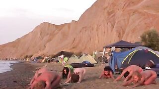 A group of nudists play volleyball on the naked beach