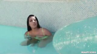 A hot girl is having swimming lessons in the pool