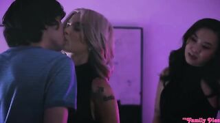 An Asian girl has sex with a European guy on the couch in a threesome